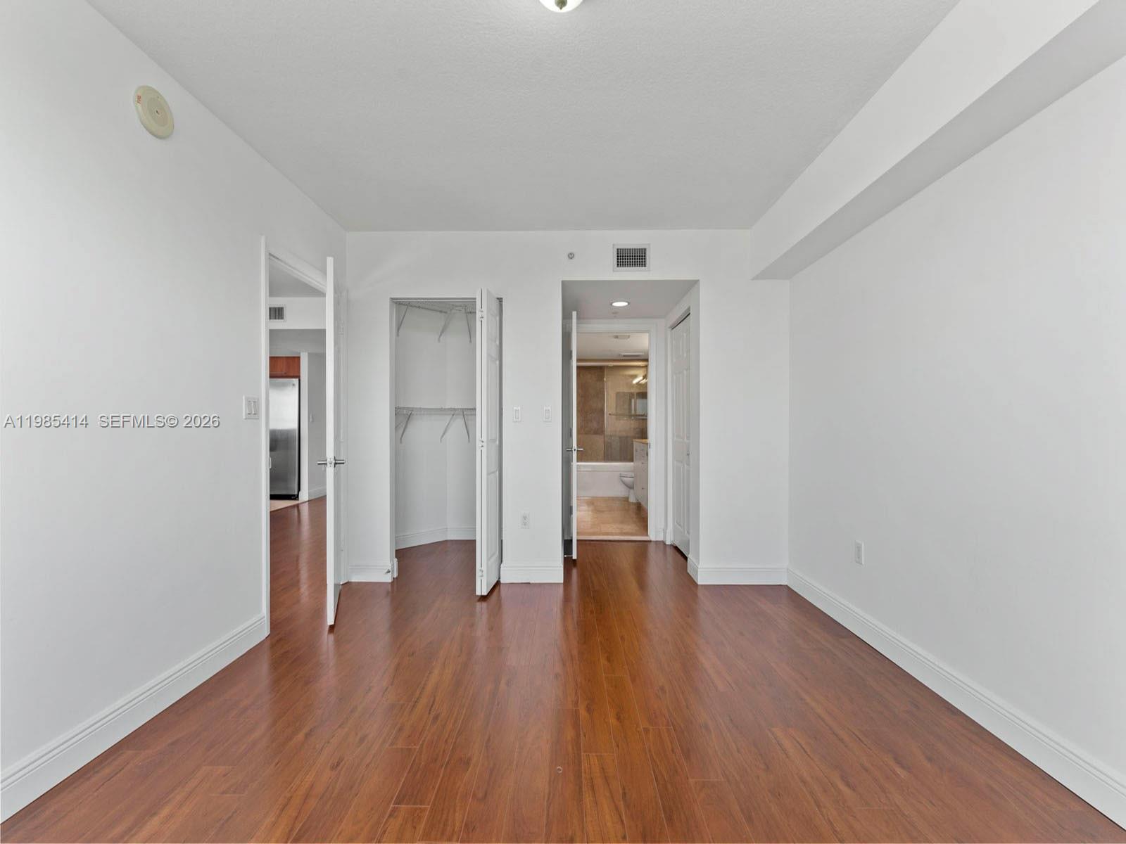 3232 Southwest 22nd Terrace, Unit 1609 Miami, FL 33145 - Photo 19 of 37 a big room with wooden floor and closet