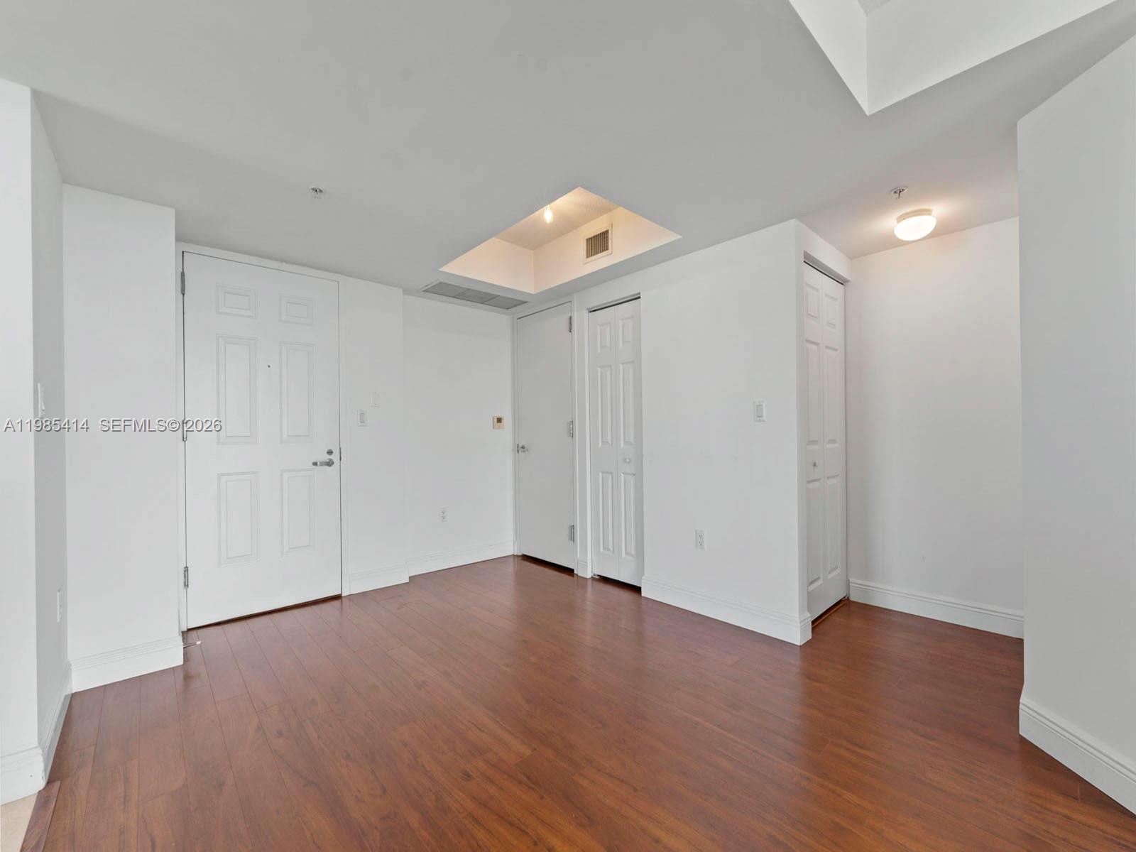 3232 Southwest 22nd Terrace, Unit 1609 Miami, FL 33145 - Photo 2 of 37 a view of an empty room with wooden floor