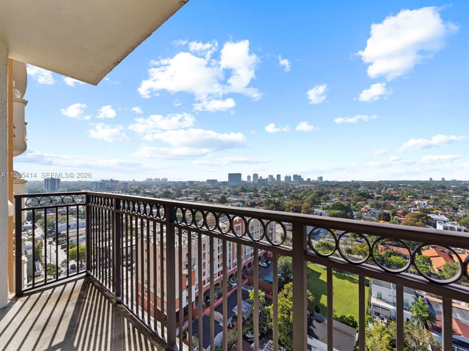 3232 Southwest 22nd Terrace, Unit 1609 Miami, FL 33145 - Photo 24 of 37 a view of a balcony with wooden floor & fence
