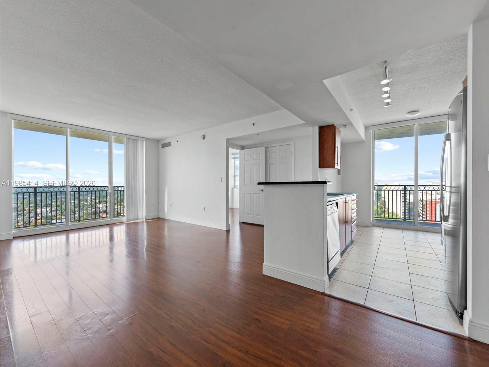 3232 Southwest 22nd Terrace, Unit 1609 Miami, FL 33145 - Photo 3 of 37 a view of empty room with wooden floor and fireplace