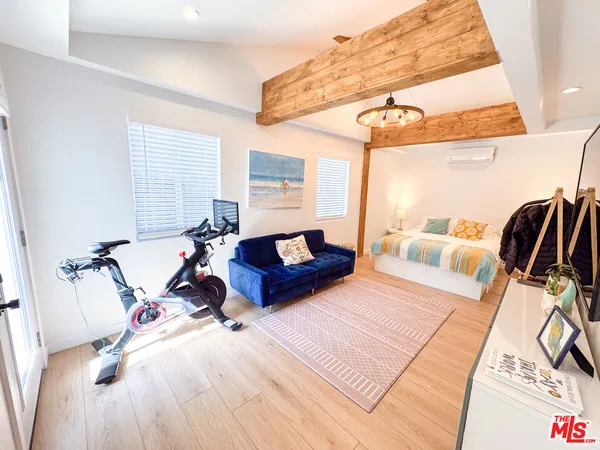 a bedroom with furniture and a wooden floor