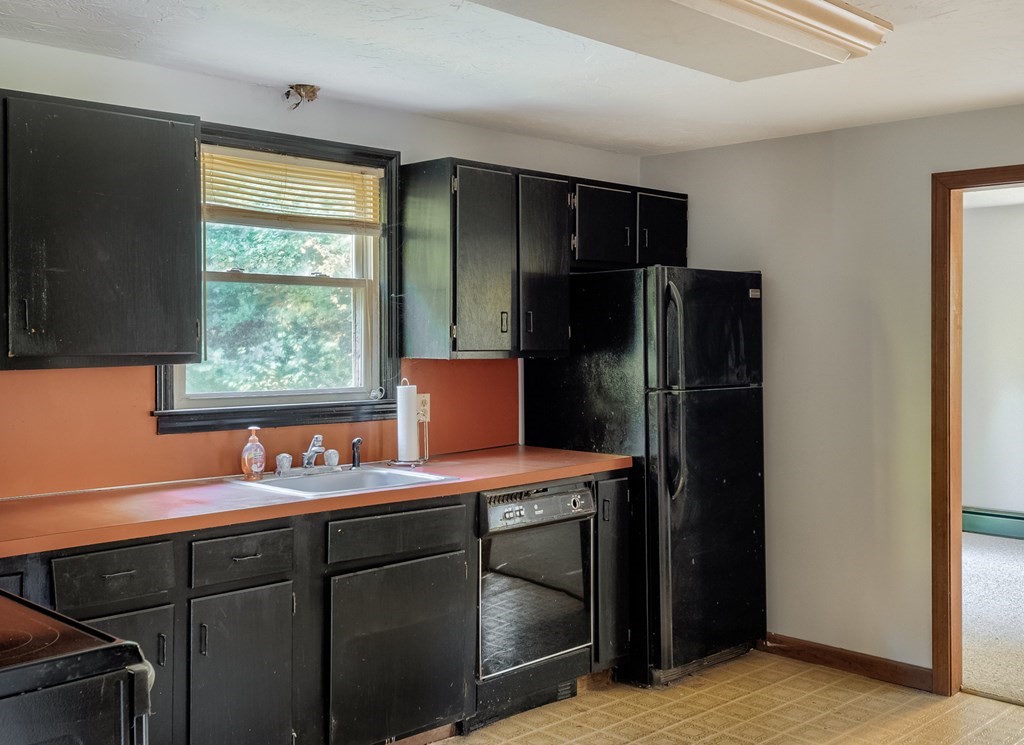 16 McIntyre Road Charlton, MA 01507 - Photo 7 of 26 a kitchen with a refrigerator and window
