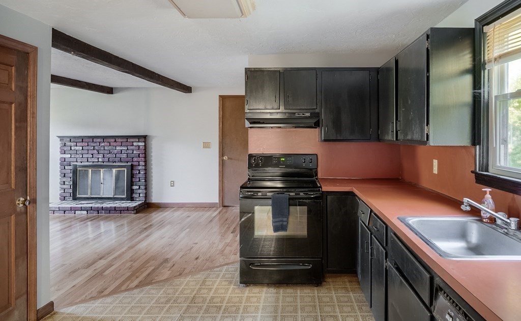 16 McIntyre Road Charlton, MA 01507 - Photo 8 of 26 a kitchen with a sink stove and cabinets