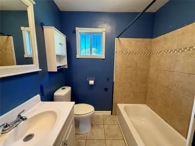 a bathroom with a sink a toilet and bathtub