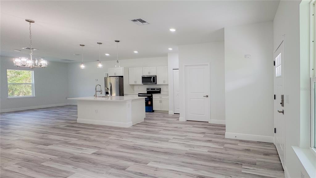15625 Southwest 37th Circle Ocala, FL 34473 - Photo 3 of 27 a view of kitchen with kitchen island stainless steel appliances refrigerator stove microwave and cabinets