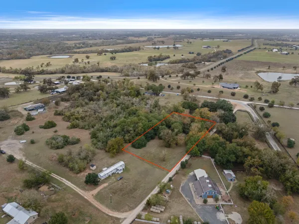 an aerial view of a residential houses with outdoor space