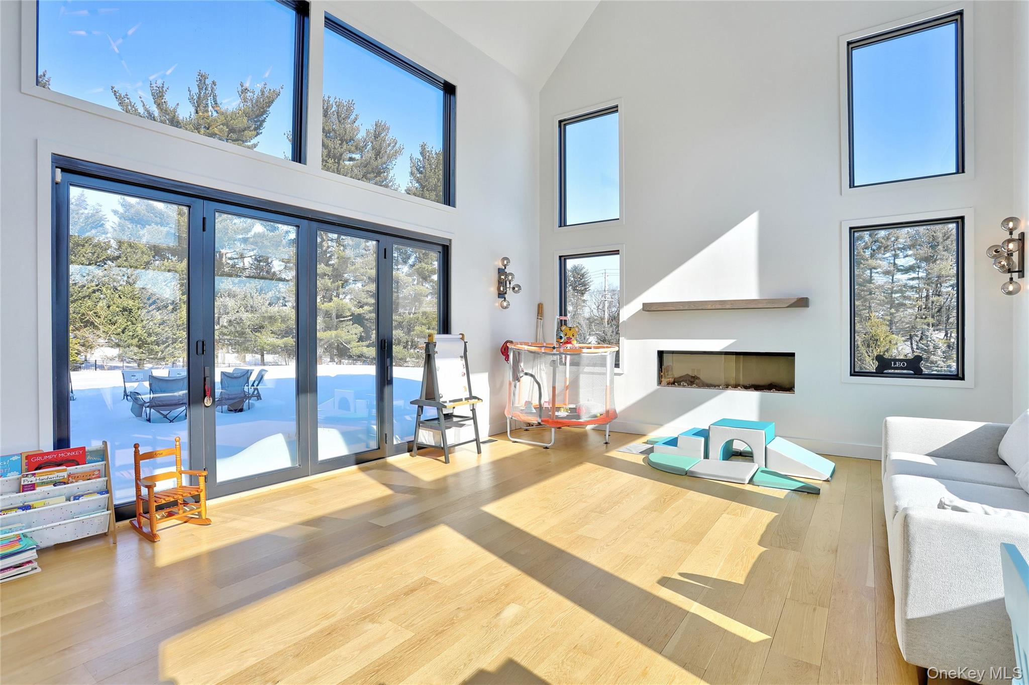 37 Harvest Road New City, NY 10956 - Photo 15 of 33 a living room with furniture a flat screen tv and a floor to ceiling window