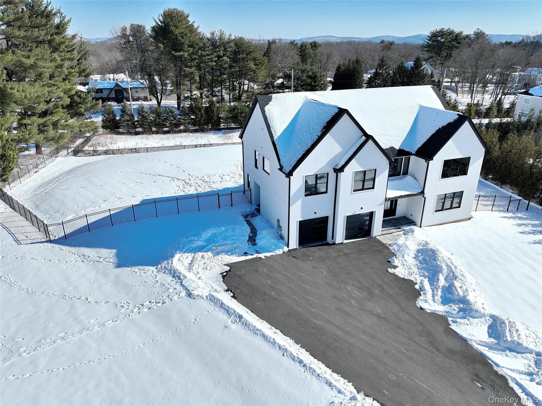 37 Harvest Road New City, NY 10956 - Photo 30 of 35 a view of a white house next to a road with large trees