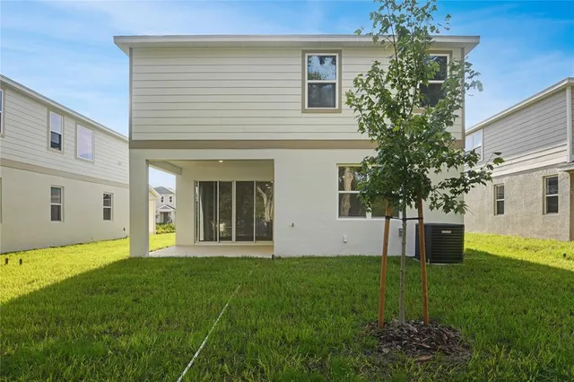 a front view of a house with a yard and trees