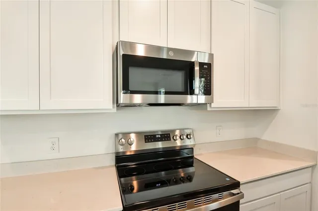 a kitchen with a stove and a microwave