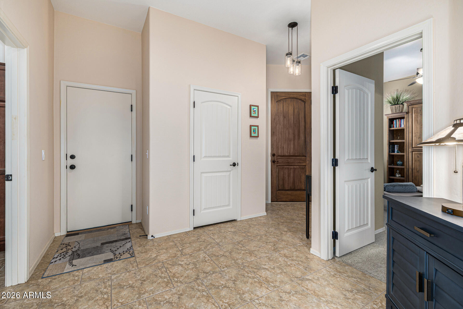 6202 East McKellips Road, Unit 297 Mesa, AZ 85215 - Photo 11 of 57 an empty room with kitchen view and a chandelier