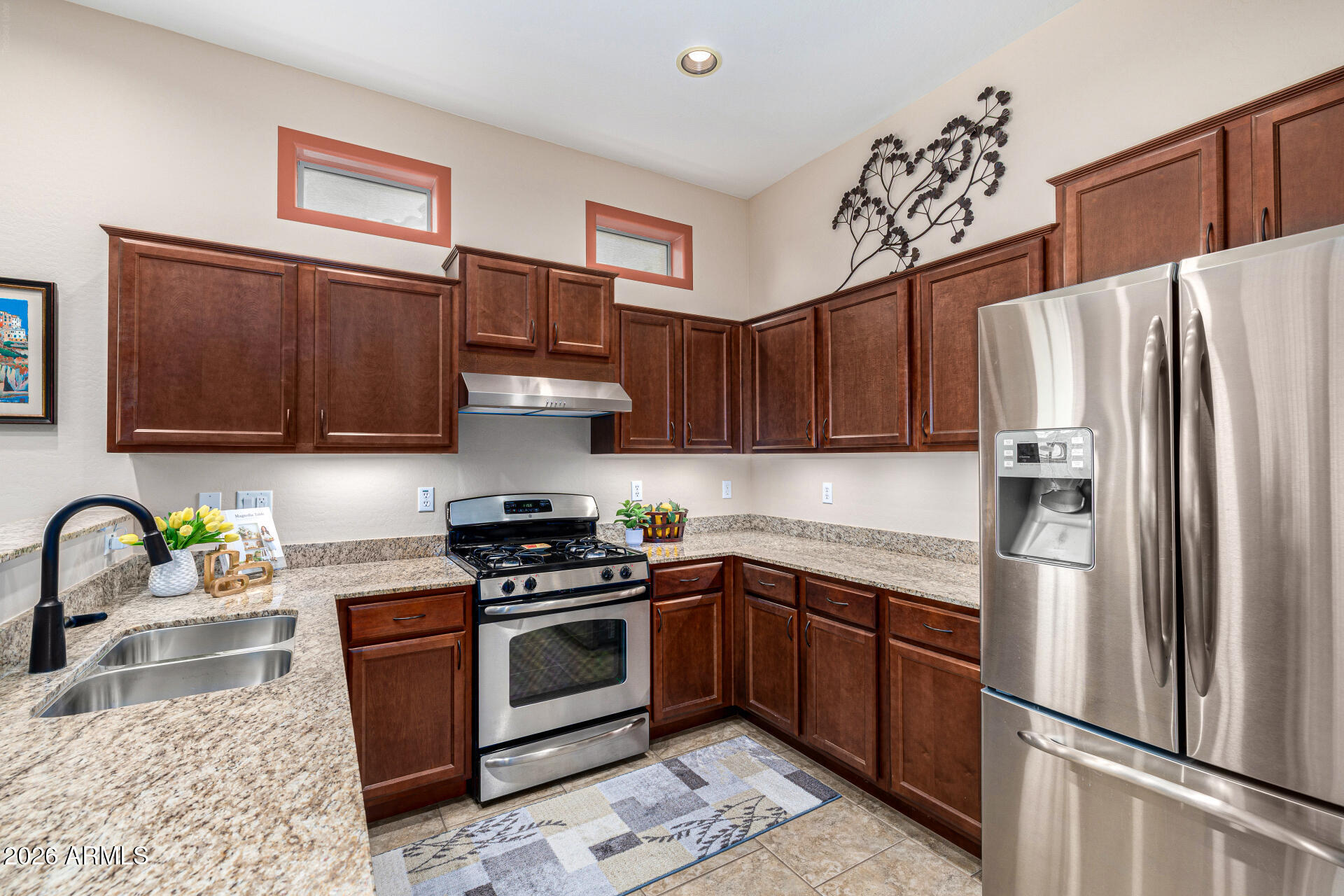 6202 East McKellips Road, Unit 297 Mesa, AZ 85215 - Photo 14 of 57 a kitchen with stainless steel appliances granite countertop a refrigerator sink and stove