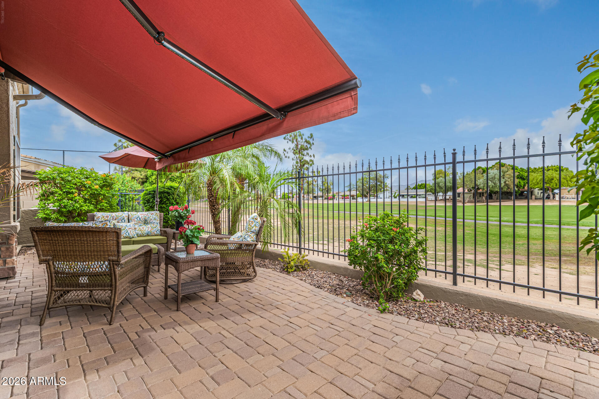 6202 East McKellips Road, Unit 297 Mesa, AZ 85215 - Photo 40 of 57 a view of a patio with table and chairs potted plants with wooden floor and fence