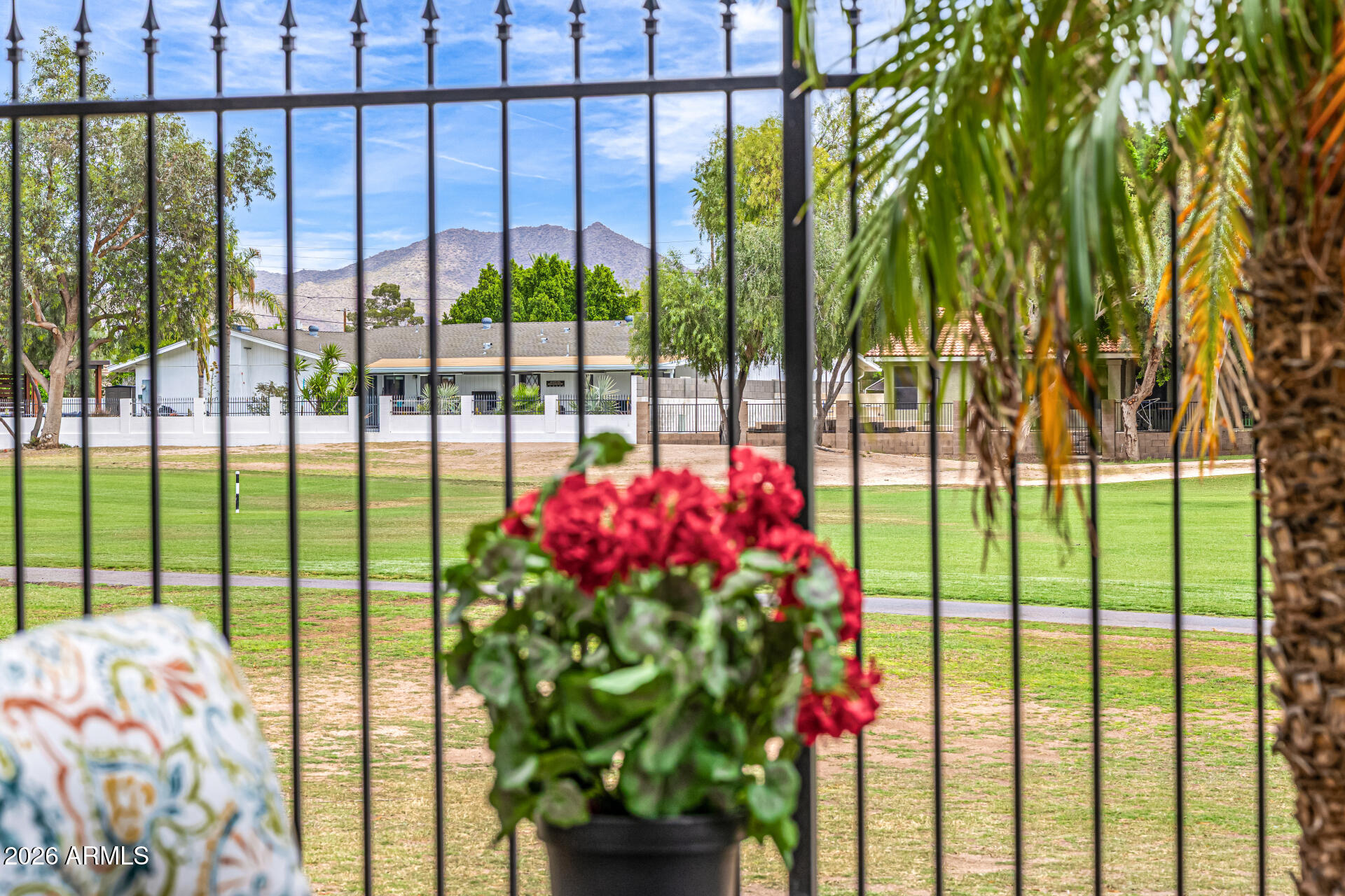 6202 East McKellips Road, Unit 297 Mesa, AZ 85215 - Photo 43 of 57 a view of a multi story building with a big yard and fountain