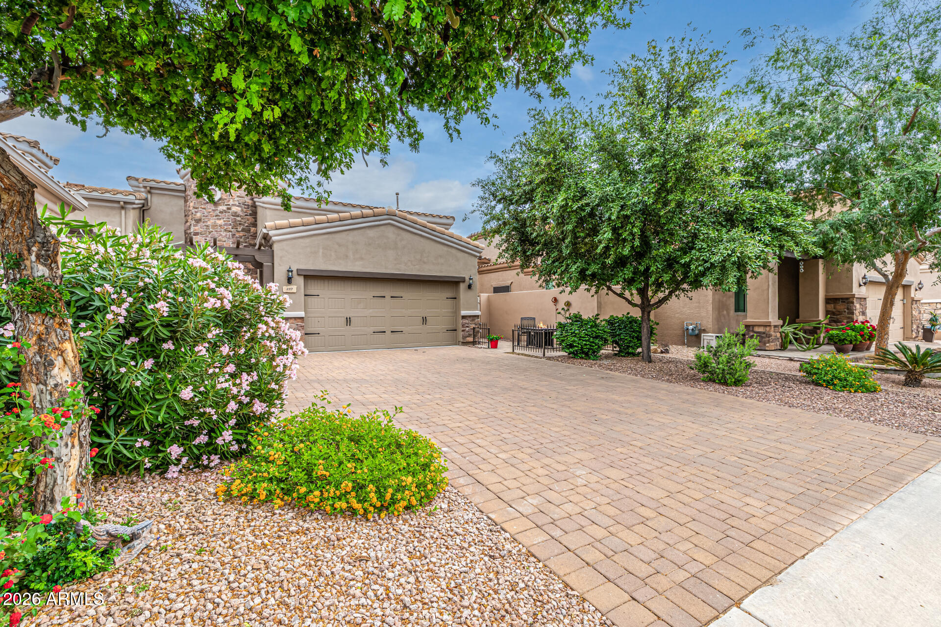 6202 East McKellips Road, Unit 297 Mesa, AZ 85215 - Photo 4 of 57 a front view of a house with a yard and a garage