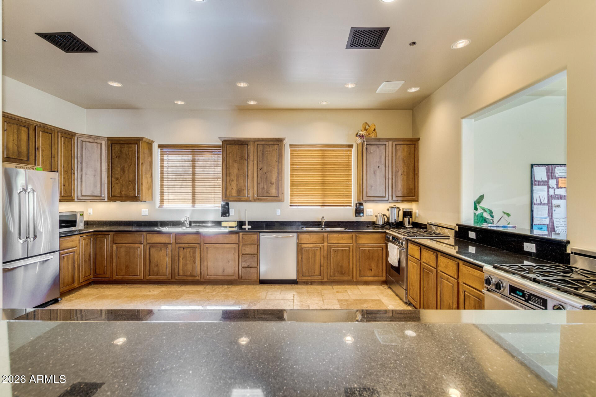 6202 East McKellips Road, Unit 297 Mesa, AZ 85215 - Photo 50 of 57 a large kitchen with granite countertop a large counter top stainless steel appliances and windows