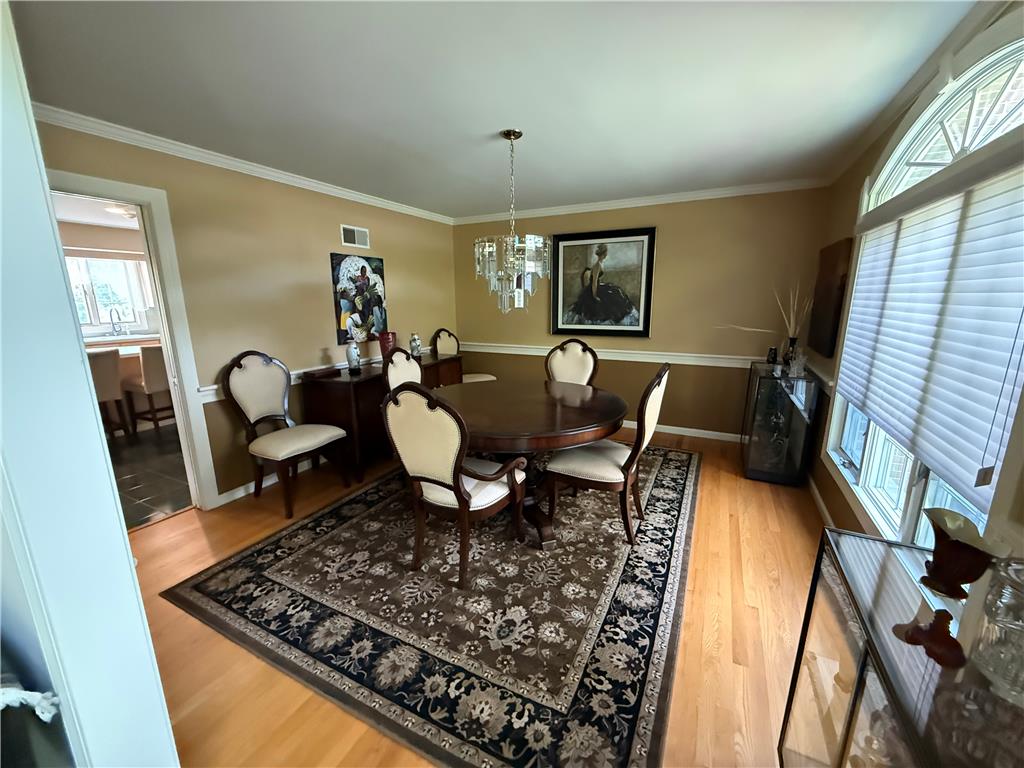 4114 Rochelle Drive Allentown, PA 18104 - Photo 6 of 35 Elegant crown molding and rich hardwood floors define this inviting dining area, ideal for gatherings.