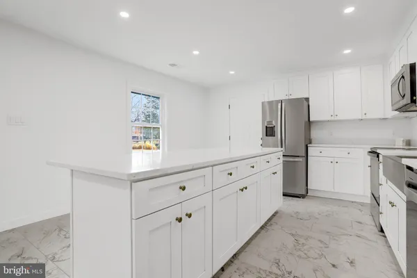 a kitchen with sink refrigerator and cabinets