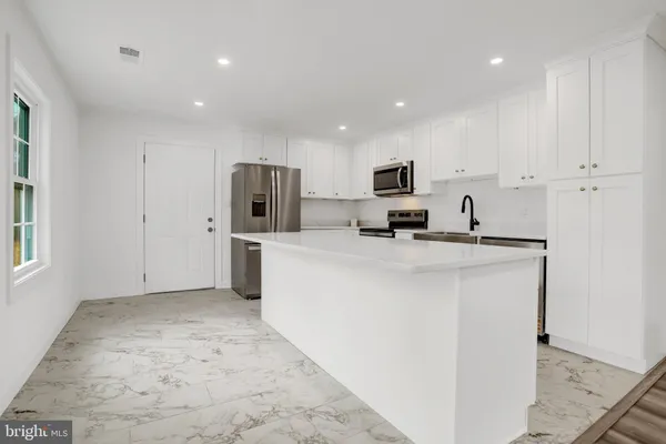 a kitchen with refrigerator and microwave