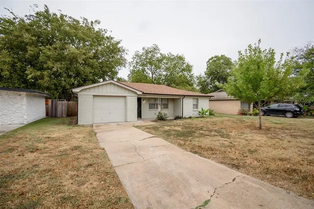a front view of house with yard and trees