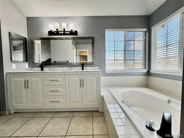 a kitchen with granite countertop a sink and a refrigerator