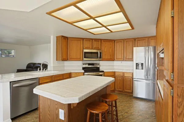 a view of a dining room with furniture a chandelier and wooden floor