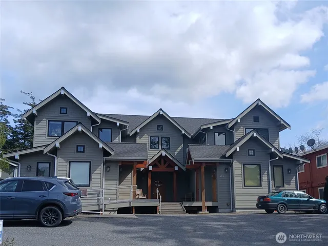 a front view of a house with a parking space