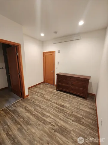 a view of room with wooden floor