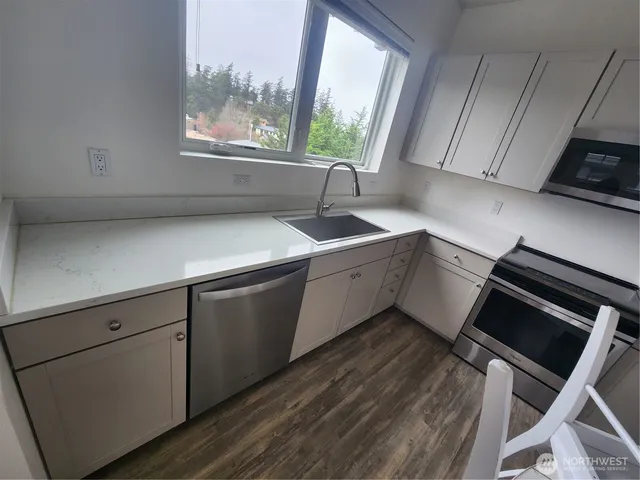 a kitchen with a sink cabinets and window