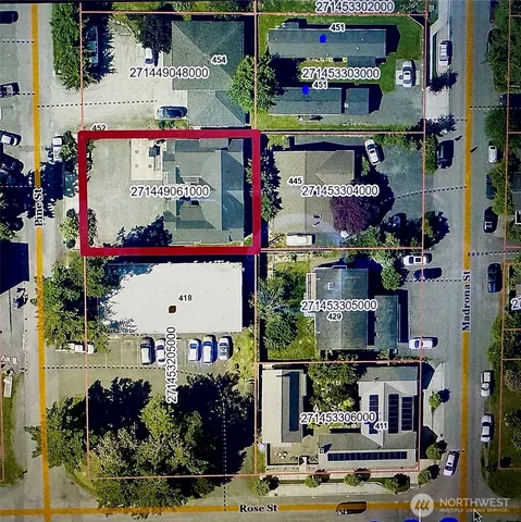 a front view of multi story building with retail shops