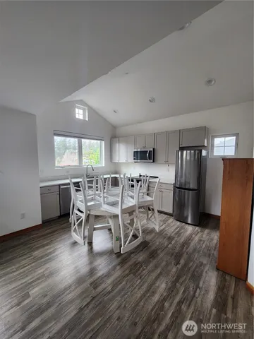 a dining room with furniture and wooden floor