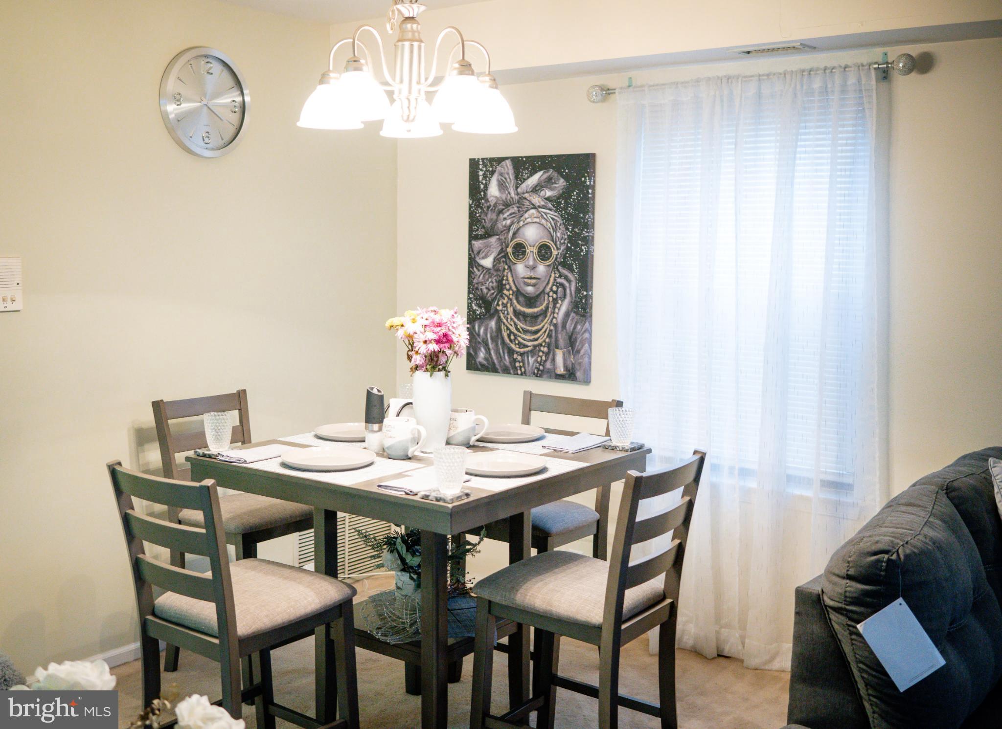 2089 Welsh Road, Unit F1 Philadelphia, PA 19115 - Photo 11 of 27 a view of a dining room with furniture wooden floor and a chandelier