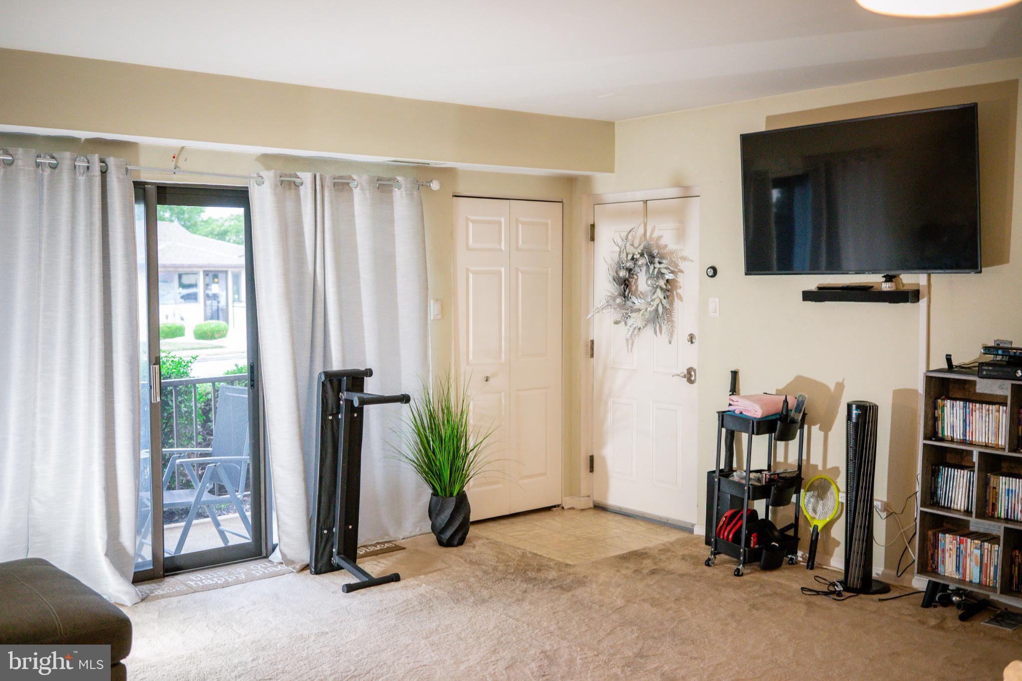 2089 Welsh Road, Unit F1 Philadelphia, PA 19115 - Photo 6 of 27 a view of a livingroom with furniture and a flat screen tv