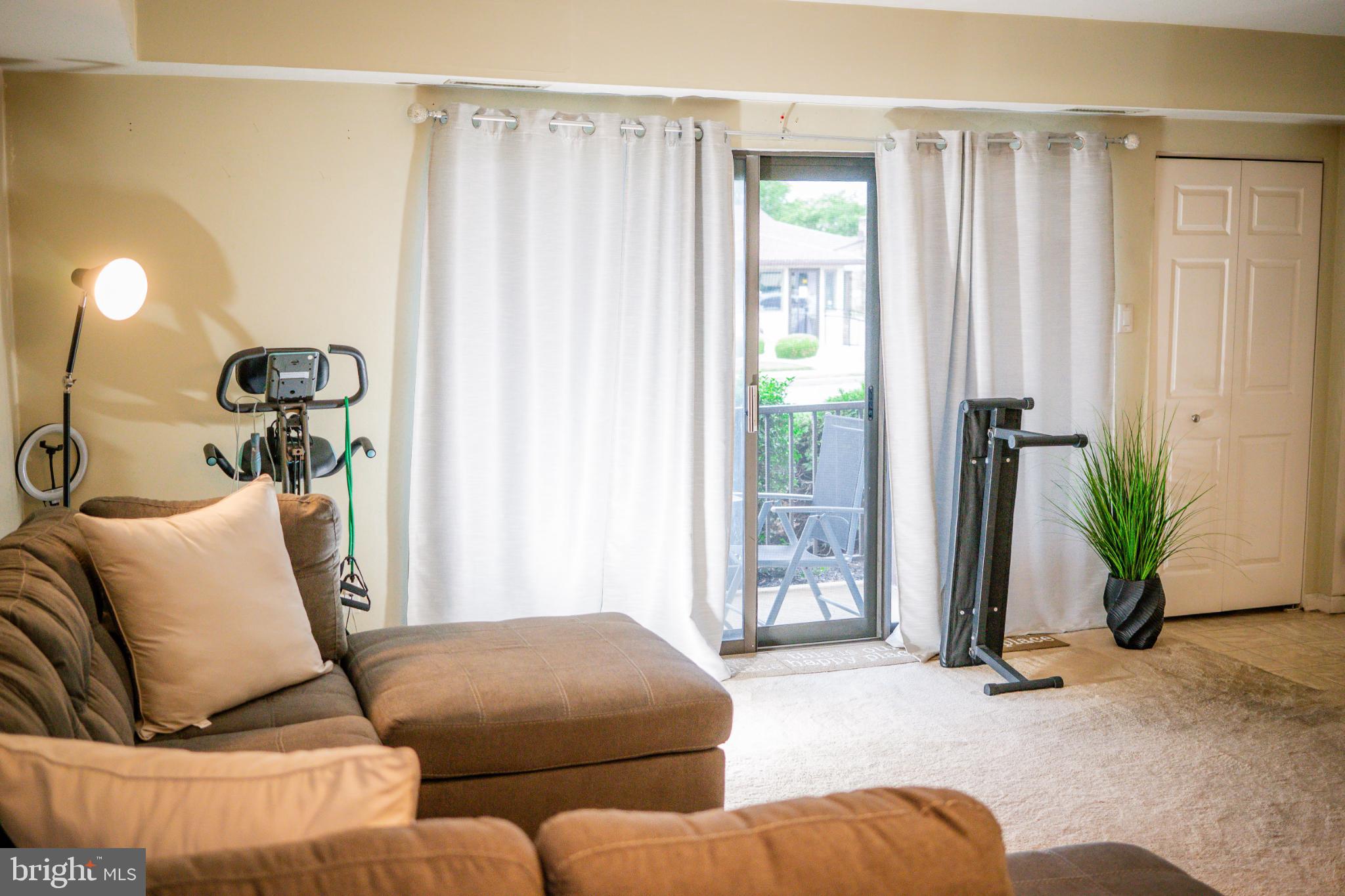 2089 Welsh Road, Unit F1 Philadelphia, PA 19115 - Photo 7 of 27 a living room with furniture and a window