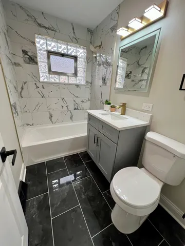 a bathroom with a toilet a sink and mirror