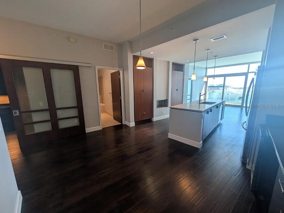 912 Channelside Drive, Unit 2803 Tampa, FL 33602 - Photo 2 of 34 a view of a hallway with wooden floor windows and a kitchen view