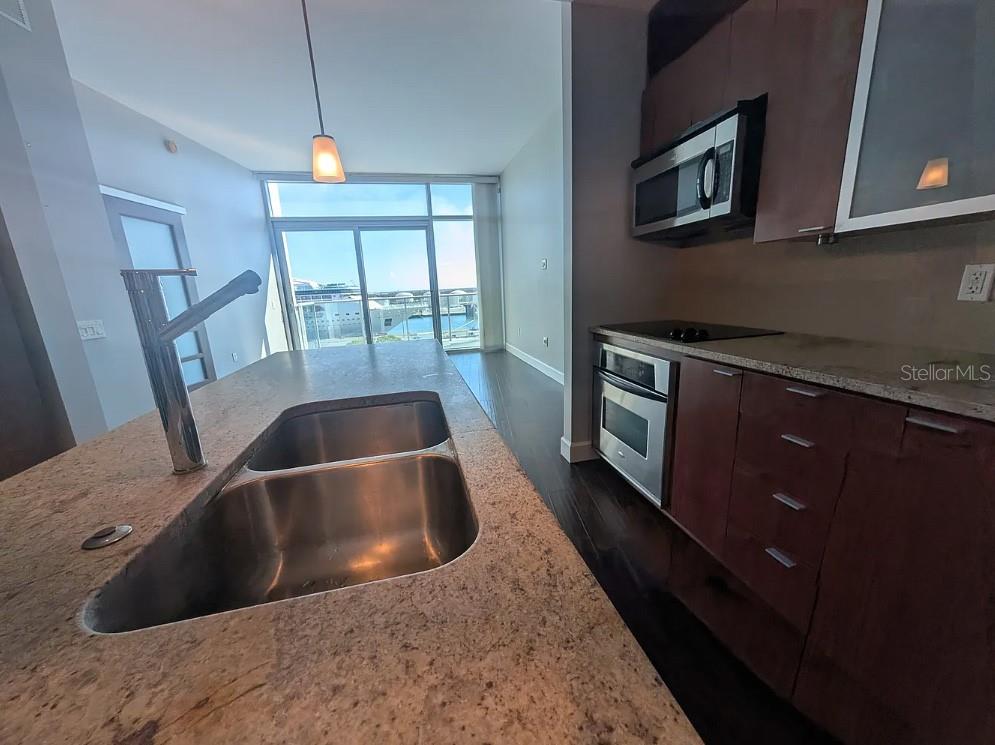 912 Channelside Drive, Unit 2803 Tampa, FL 33602 - Photo 31 of 34 a kitchen with a sink and a stove top oven