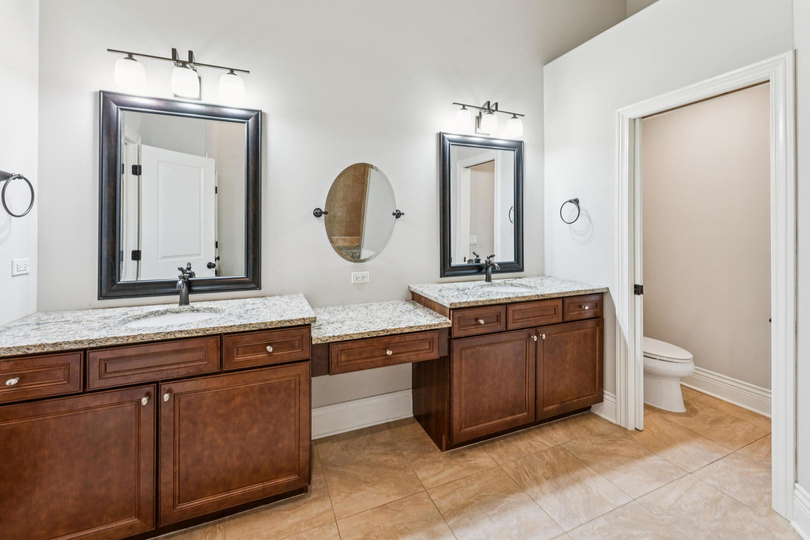 1407 Rue Paris Place Inverness, IL 60067 - Photo 15 of 38 a bathroom with a granite countertop sink a toilet and a mirror