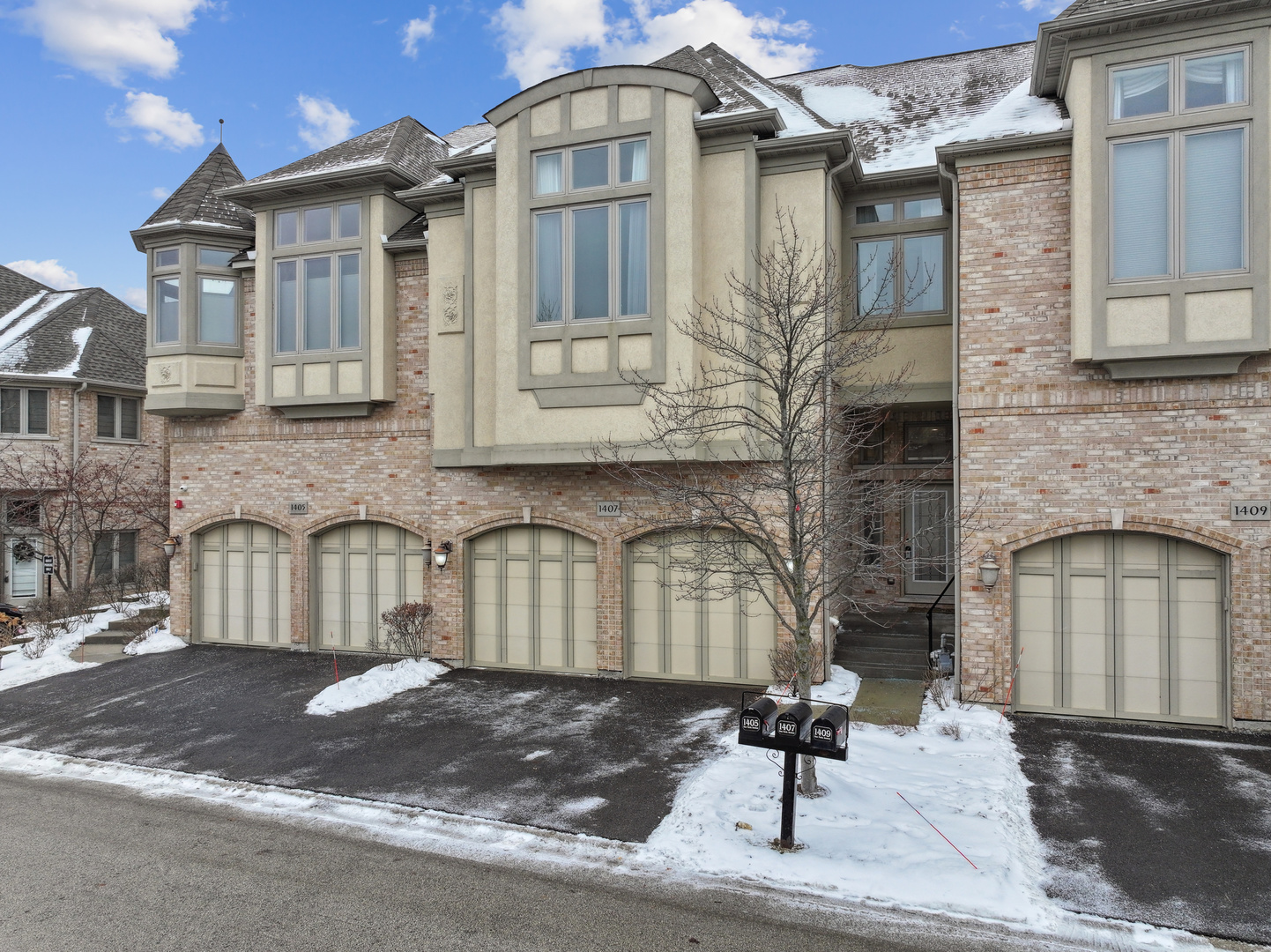 1407 Rue Paris Place Inverness, IL 60067 - Photo 2 of 38 a front view of a house with parking