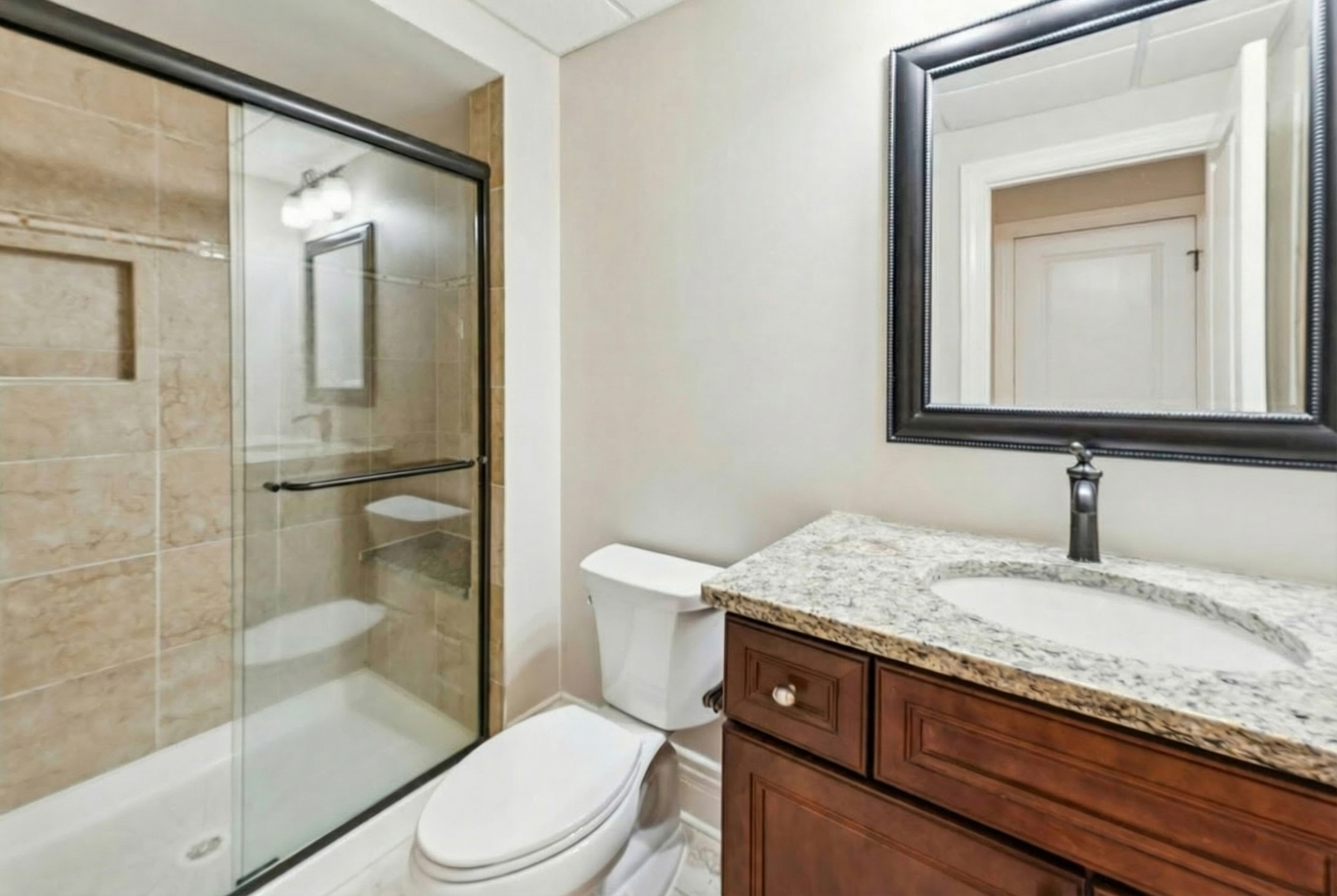 1407 Rue Paris Place Inverness, IL 60067 - Photo 27 of 38 a bathroom with a granite countertop sink toilet and shower