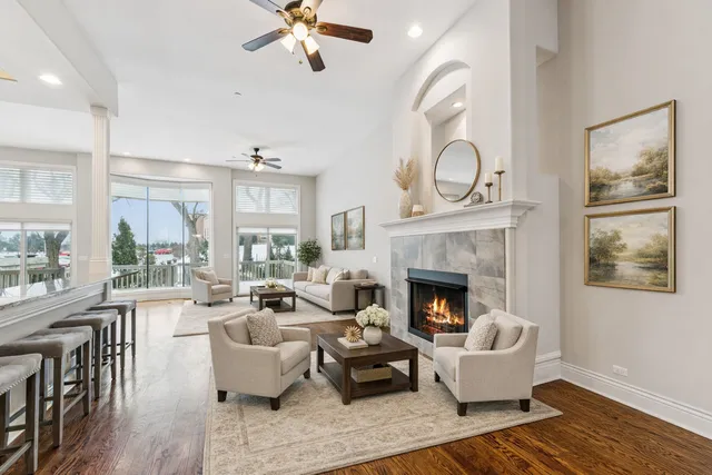 a living room with furniture fireplace and wooden floor