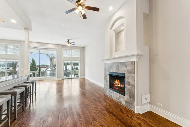 a living room with wooden floors and fireplace