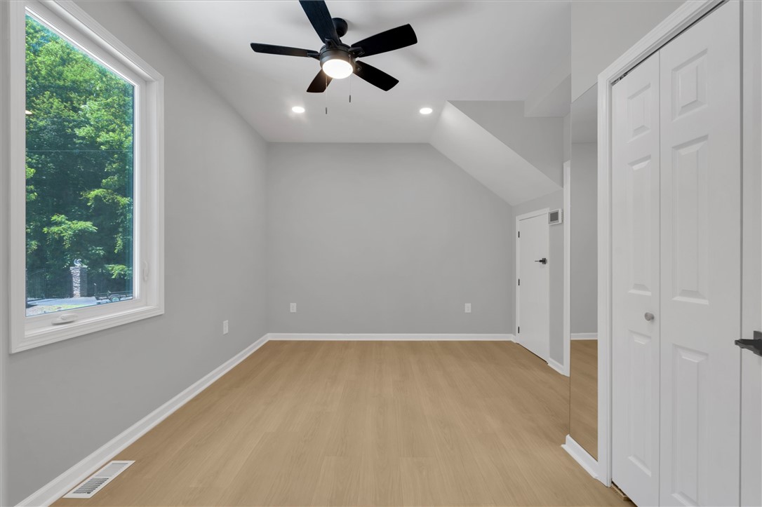 159 Cherokee Trail Easley, SC 29640 - Photo 19 of 38 A well-lit room offers wood-look flooring and a window overlooking lush greenery.
