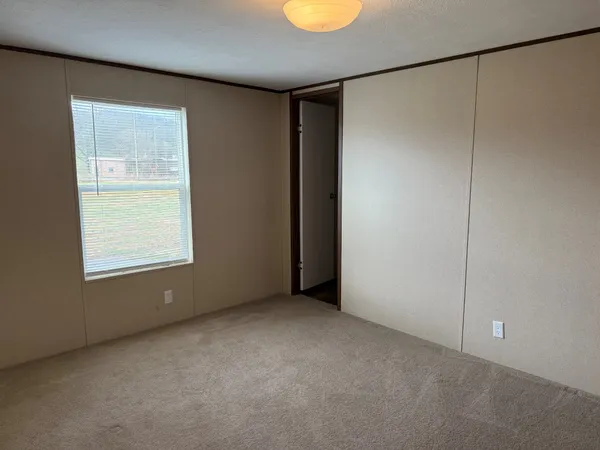 a view of an empty room with a window