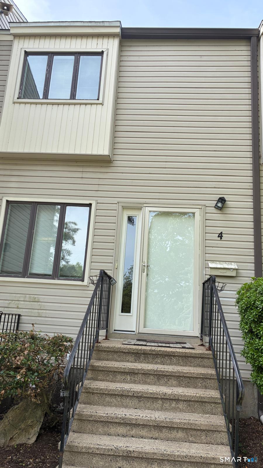 715 Frenchtown Road, Unit 4 Bridgeport, CT 06606 - Photo 3 of 6 a view of a brick house with large windows