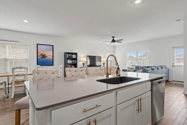a kitchen with a sink and a refrigerator