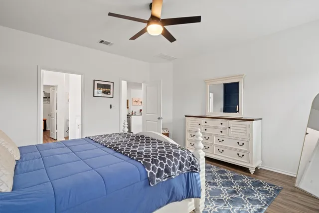 a bedroom with a bed and a dresser in it