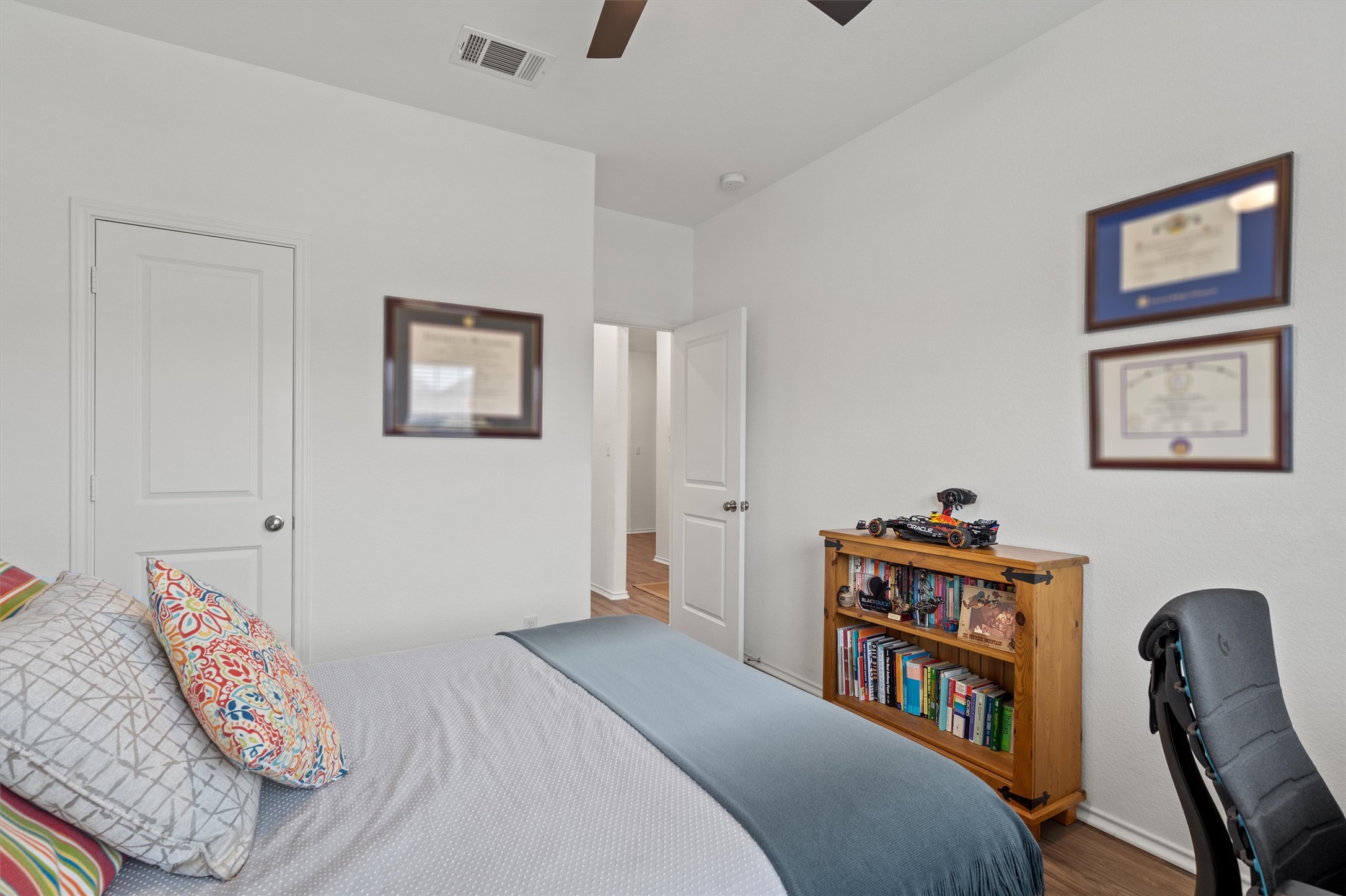424 Wolf Springs Road Georgetown, TX 78628 - Photo 21 of 37 a bedroom with bed and a bookshelf