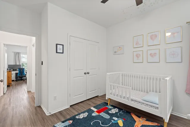 a bedroom with furniture and wooden floor