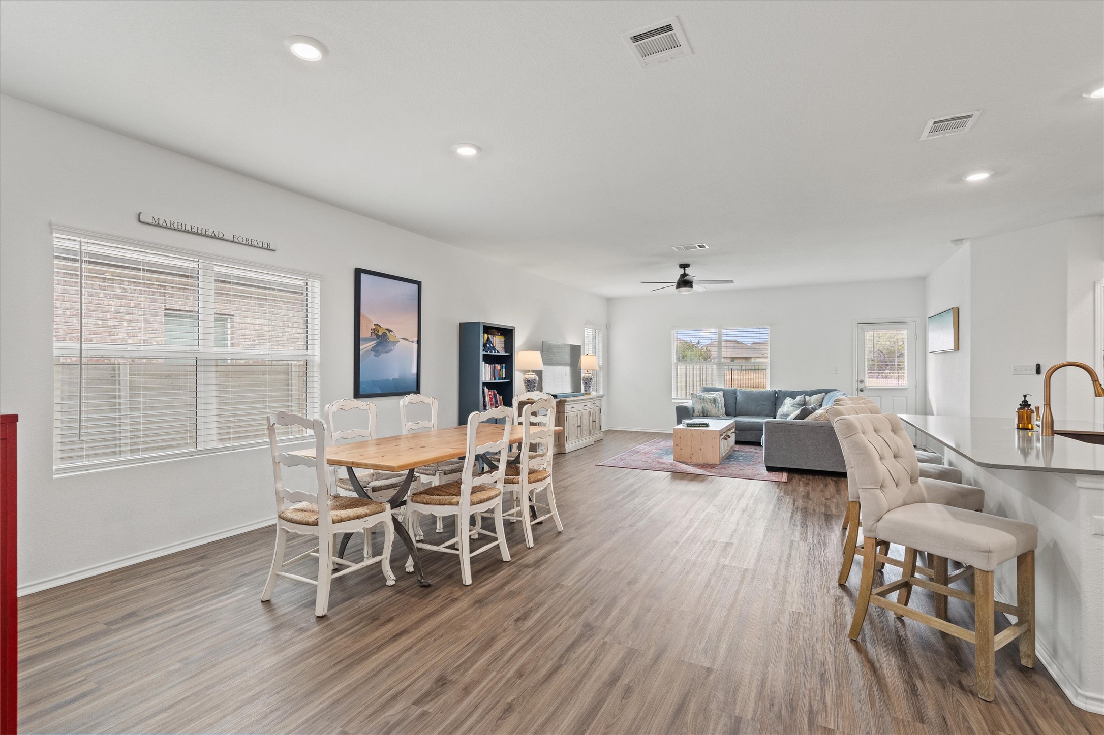 424 Wolf Springs Road Georgetown, TX 78628 - Photo 8 of 35 a dining room with furniture a chandelier and wooden floor